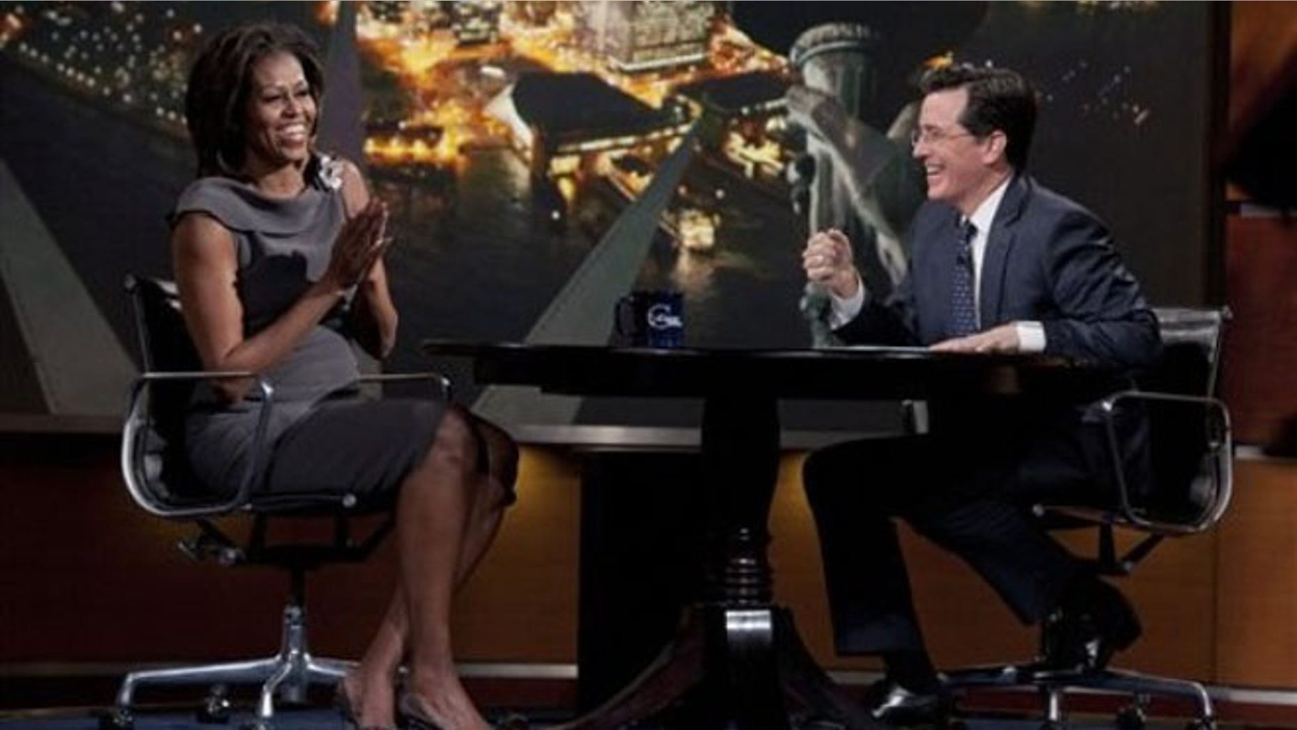 April 11, 2012: In this photo provided by Comedy Central, first lady Michelle Obama laughs with Stephen Colbert during her appearance on The Colbert Report.