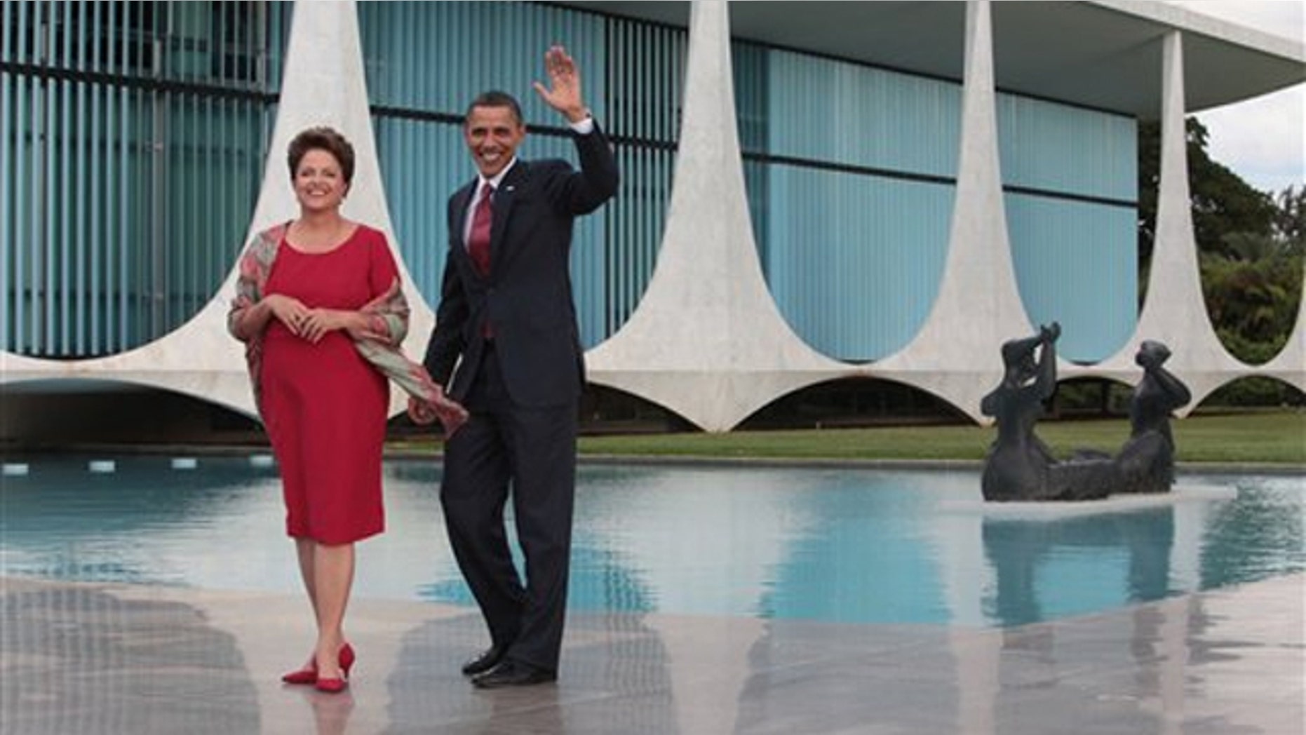 Saturday: President Obama, accompanied by Brazil's President Dilma Rousseff, waves as he arrives in Brasilia, Brazil.