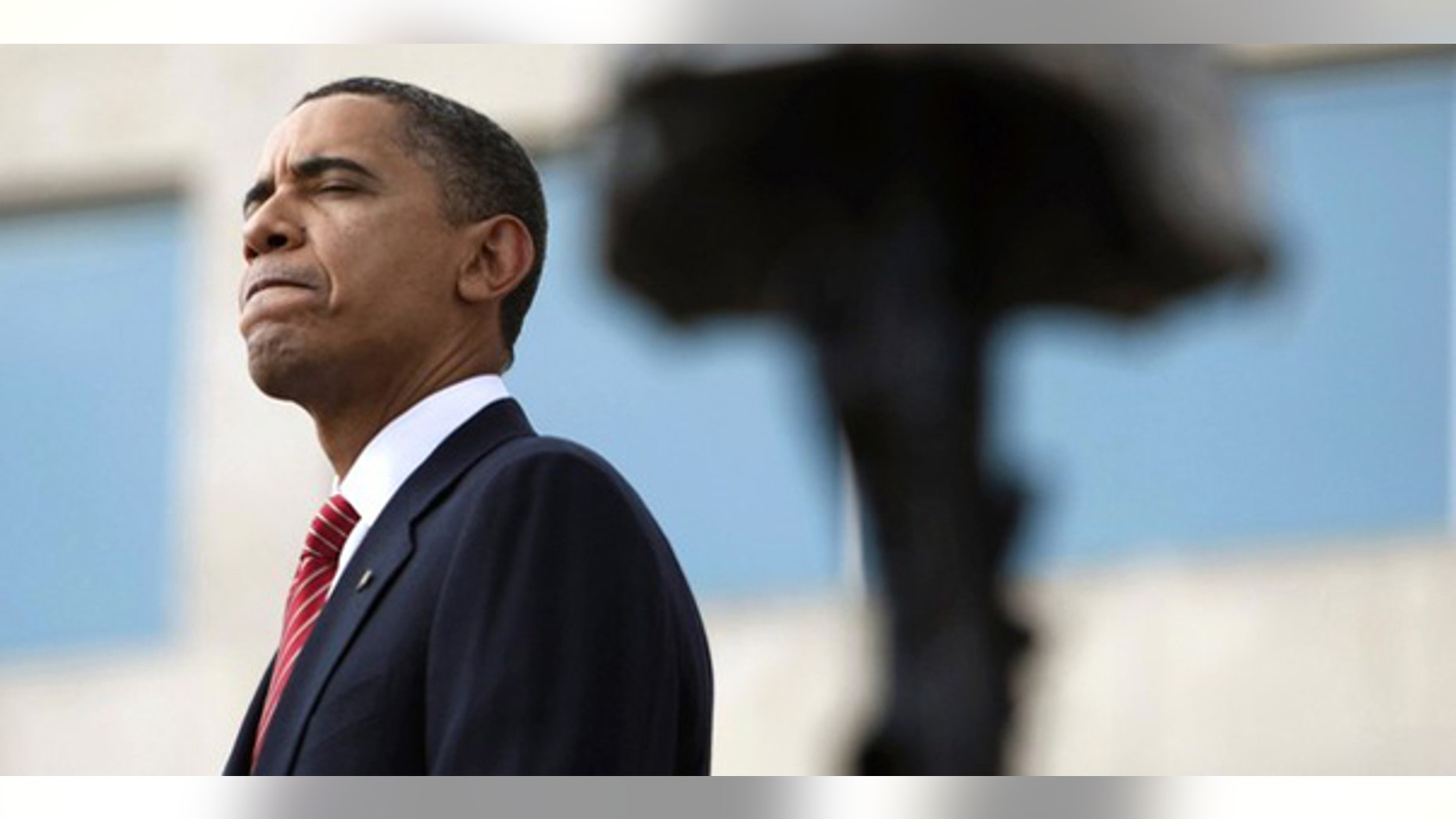 President Obama pauses as he speaks behind the helmet and weapon of one of the fallen soldiers during the III Corps and Fort Hood Memorial Ceremony November 10, 2009. (Reuters)