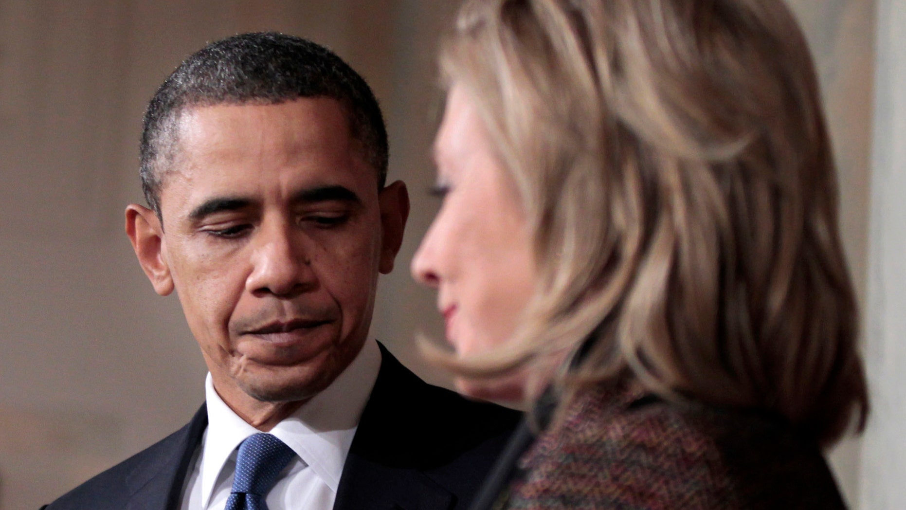 Wednesday: President Obama and Secretary of State Hillary Clinton walk away from the podium after delivering a statement on Libya in the Grand Foyer of the White House in Washington.