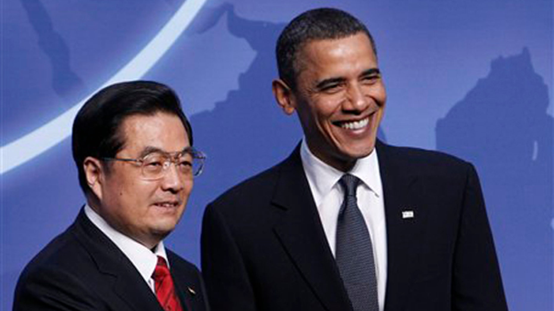President Obama greets Chinese President Hu Jintao at the Nuclear Security Summit in Washington April 12. (AP Photo)
