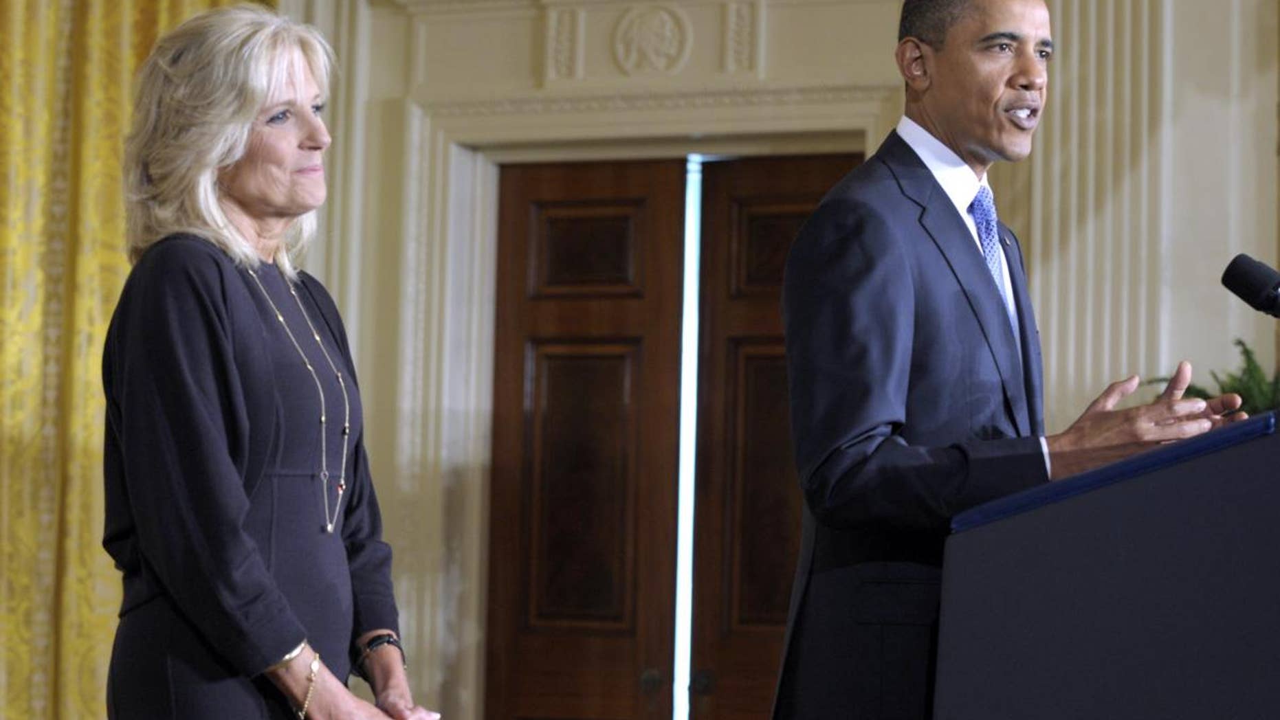 President Barack Obama speaks at the Community College Summit as Dr. Jill Biden, left, listens in the East Room of the White House in Washington, Tuesday, Oct. 5, 2010. (AP Photo/Susan Walsh)