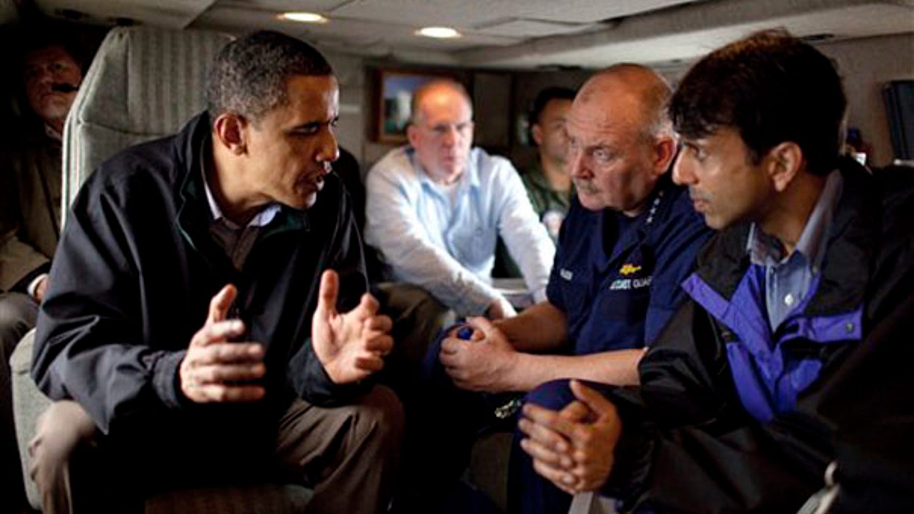 In this photo released by the White House, President Obama talks with U.S. Coast Guard Commandant Adm. Thad Allen, second right, and Louisiana Gov. Bobby Jindal aboard Marine One as they fly along the coastline from Venice, La., to New Orleans on May 2. (AP Photo)