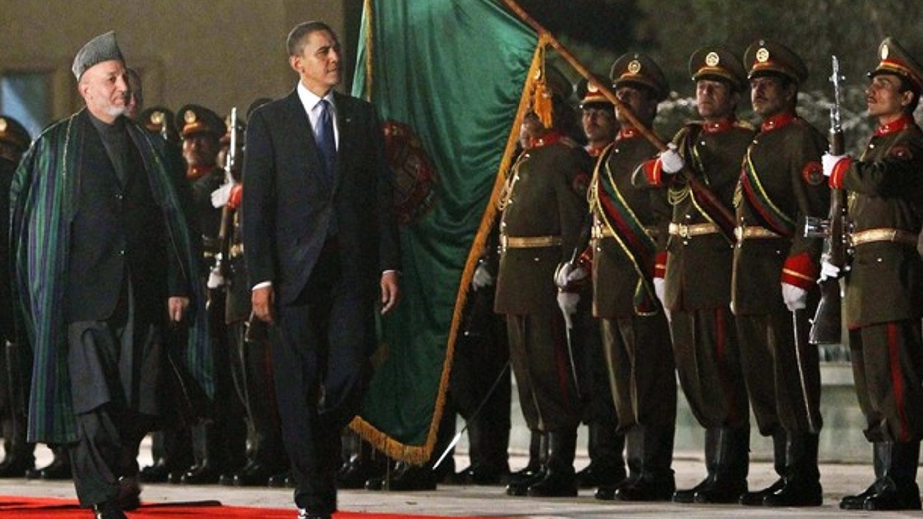 Sunday: President Obama inspects a guard of honor with Afghan President Hamid Karzai at the Presidential Palace in Kabul, where Obama arrived unannounced for his first visit to the war zone since his election as U.S. commander-in-chief. (Reuters)