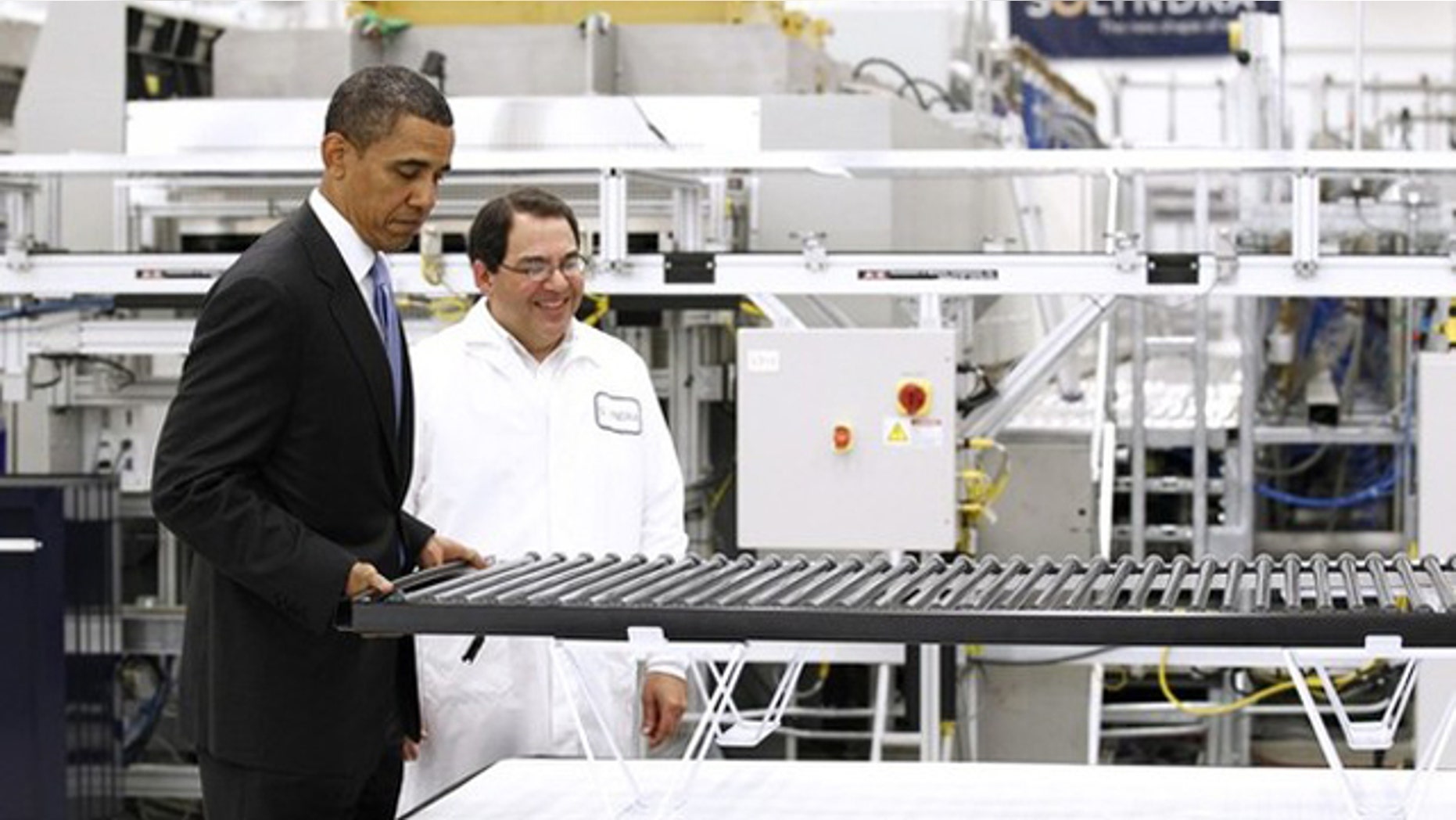 May 26, 2010: President Obama lifts a solar panel as he tours a Solyndra facility in Fremont, Calif.