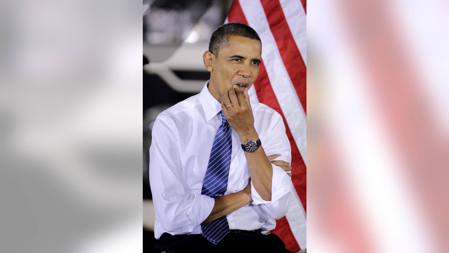 President Barack Obama listens as Vice President Joe Biden speaks at the Chrysler Indiana Transmission Plant II in Kokomo, Ind., Tuesday, Nov. 23, 2010. (AP Photo/Darron Cummings)