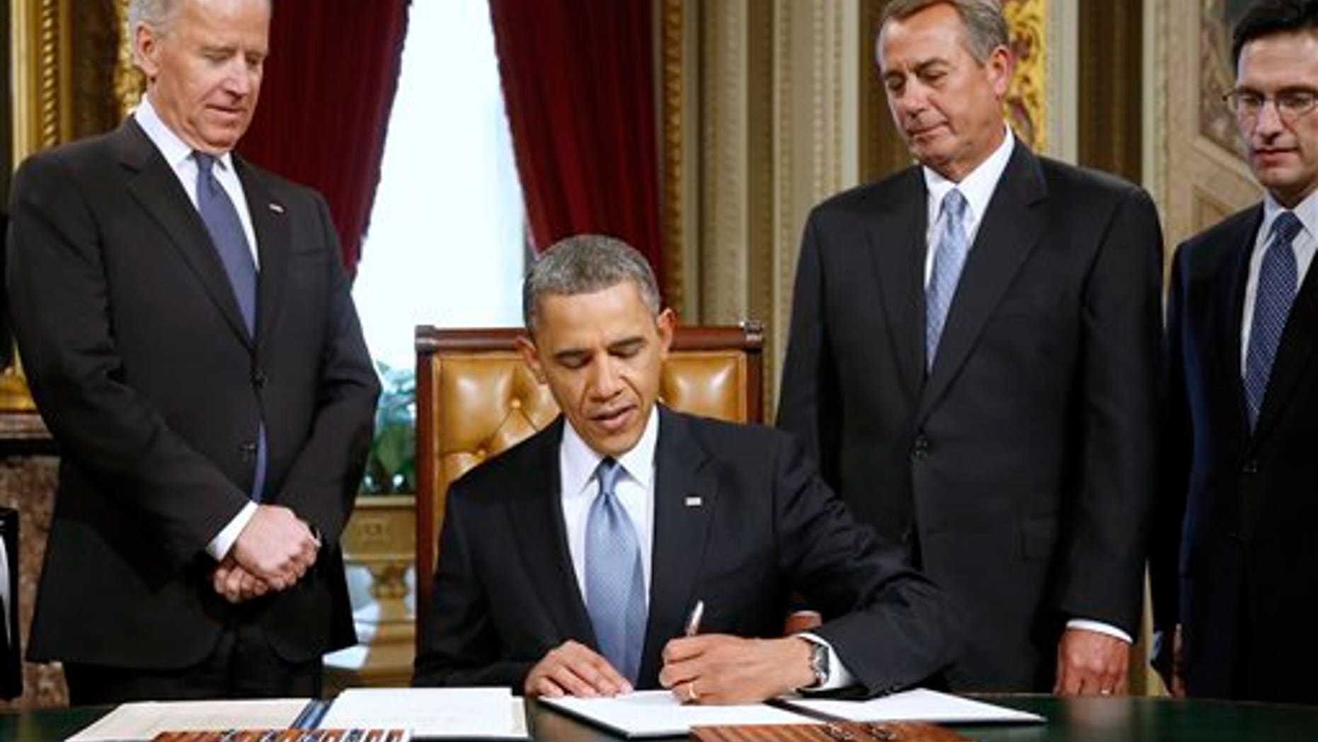 FILE: Jan. 21, 2013: President Obama signs a proclamation to commemorate the inauguration, on Capitol Hill, in Washington.