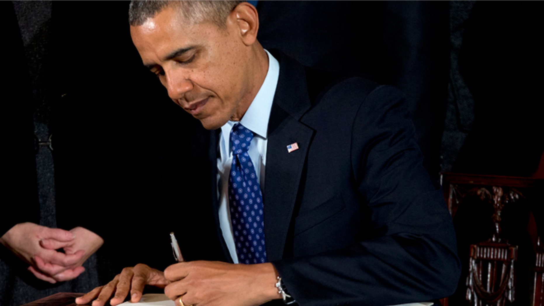 Jan. 22, 2014: President Barack Obama signs a memorandum creating a task force to respond to campus rapes during an event for the Council on Women and Girls in the East Room of the White House in Washington.