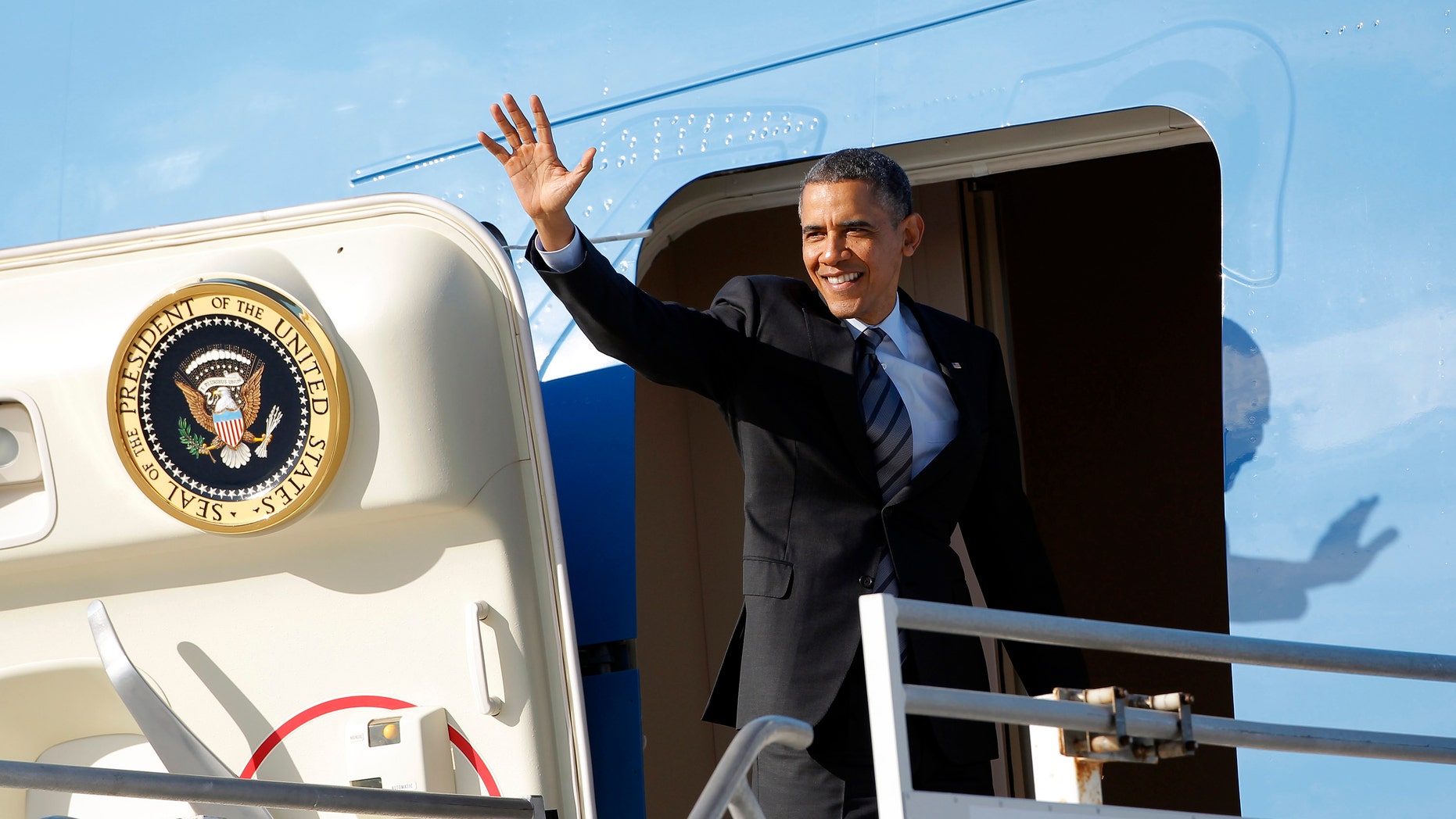 Nov 26, 2013: President Barack Obama waves as he leaves Los Angeles International Airport.