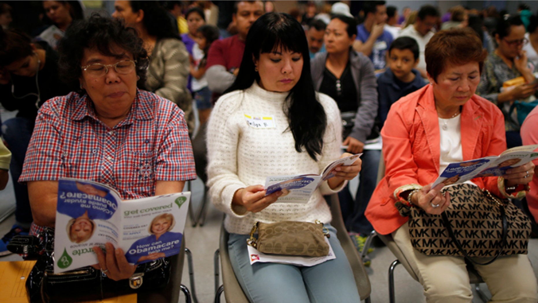March 27, 2014: People wait in line at a health insurance enrollment event in Cudahy, Calif.
