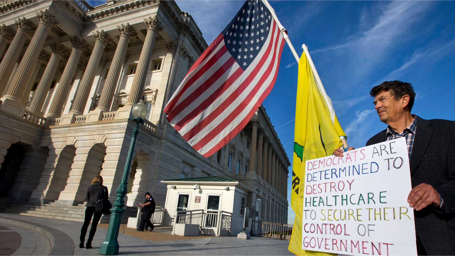 Ron Kirby, a member of the Tea Party, holds a sign against Obamacare outside the Senate side of the Capitol in Washington, Wednesday, Sept. 25, 2013.