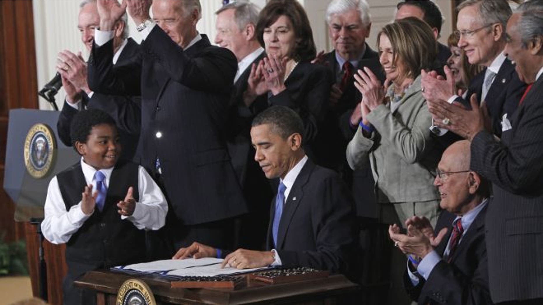 March 23, 2010: President Obama is applauded after signing the health care bill in the East Room of the White House in Washington.