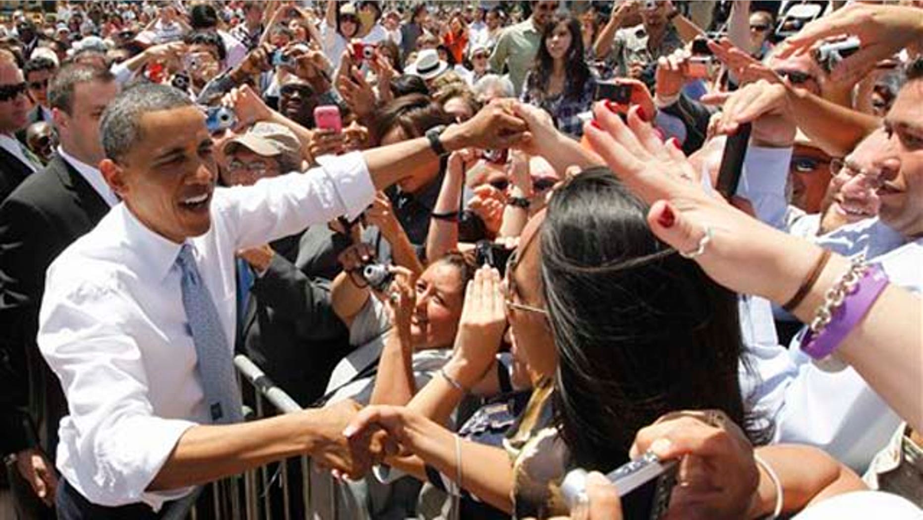 President Barack Obama greets audience members after he spoke about immigration reform at Chamizal National Memorial Park in El Paso, Texas, Tuesday, May 10, 2011. (AP Photo/Charles Dharapak)