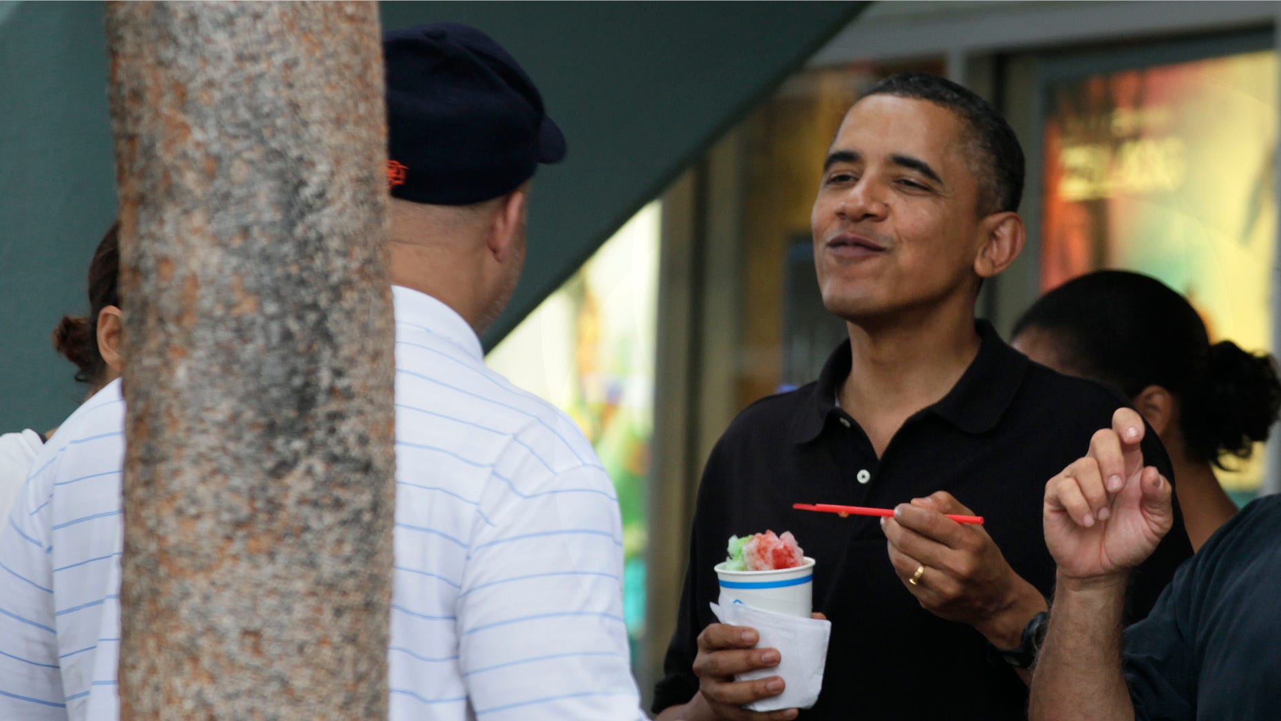 Obama shown here Dec. 27, eats Shave Ice with family and friends at Island Snow at Kailua Beach Center while on vacation with the first family in Kailua, Hawaii. Barack Obama will push back the release of his budget proposal for fiscal year 2012 by about a week, a delay administration officials blame in part on a hold placed on Obama's nominee for budget director.