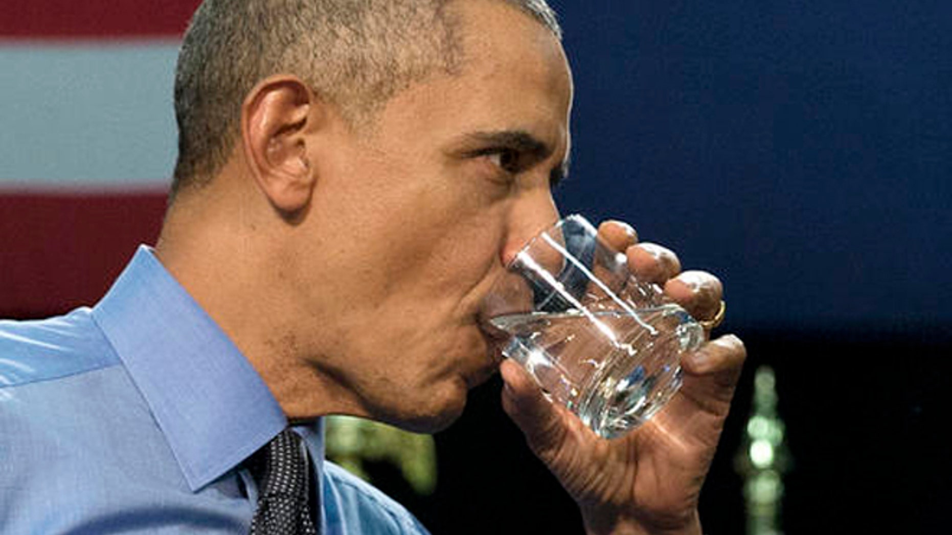 President Barack Obama drinks water as he finishes speaking at Flint Northwestern High School in Flint, Mich., Wednesday, May 4, 2016, about the ongoing water crisis.