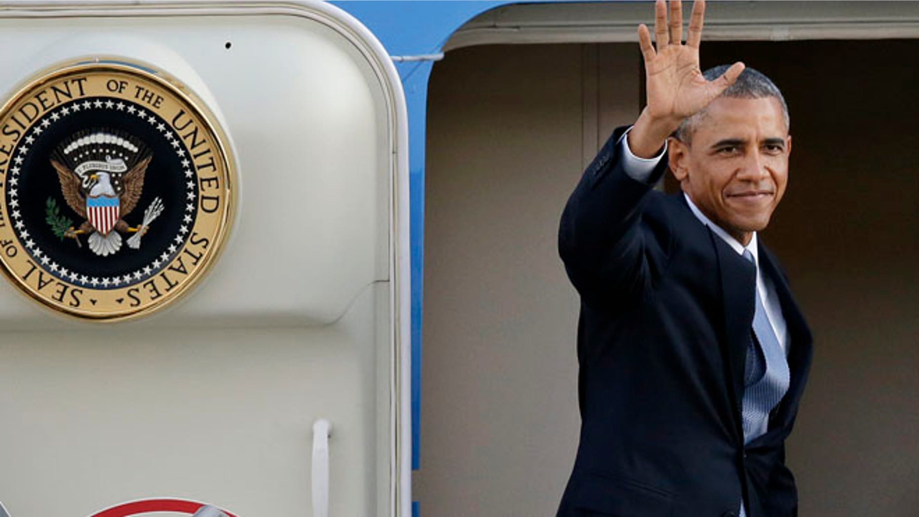 July 22, 2014: President Barack Obama waves as he prepares to depart from King County International Airport in Seattle.