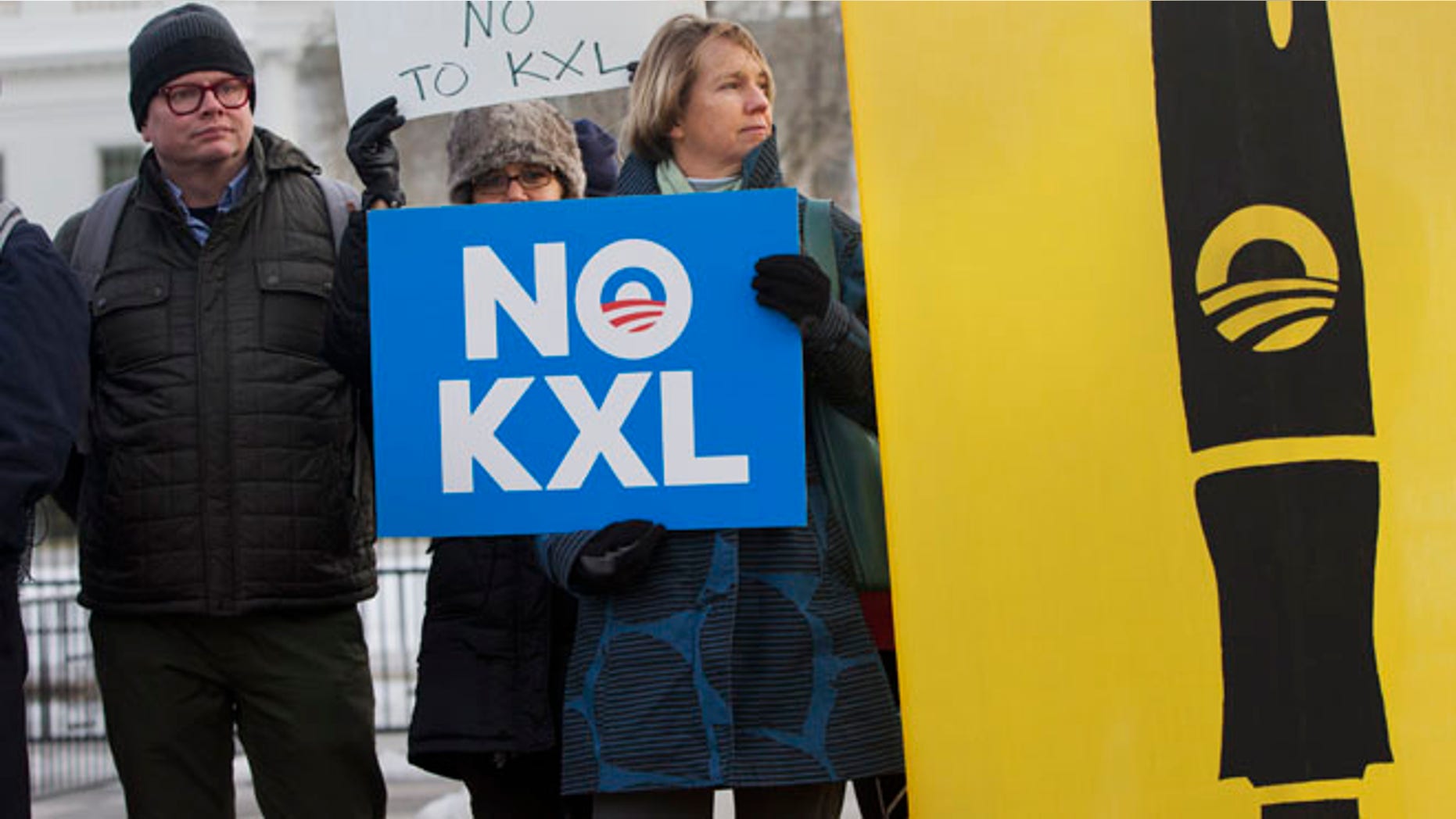 Feb. 24, 2015: Melinda Pierce, center, with the Sierra Club, holds a "No KXL" sign, next to a large poster of a pen as she gathers with other opponents of Keystone XL oil pipeline to celebrate President Barack Obama's veto of the legislation outside the White House in Washington. (AP)