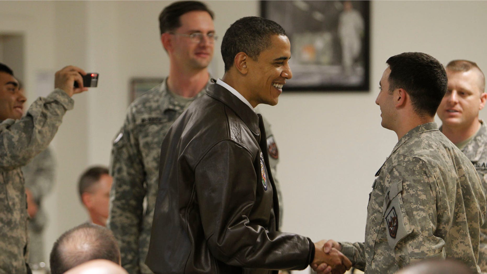 President Barack Obama greets military personnel in Dragon dining facility at Bagram Air Base in Afghanistan, Monday, March 29, 2010. (AP Photo/Charles Dharapak)
