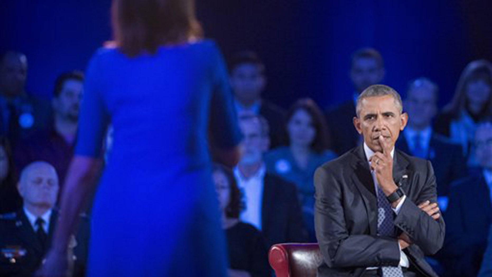 President Barack Obama, right, listens to a question from Taya Kyle, left, widow of U.S. Navy SEAL Chris Kyle, during a CNN televised town hall meeting hosted by Anderson Cooper at George Mason University in Fairfax, Va., Thursday, Jan. 7, 2016. (AP)