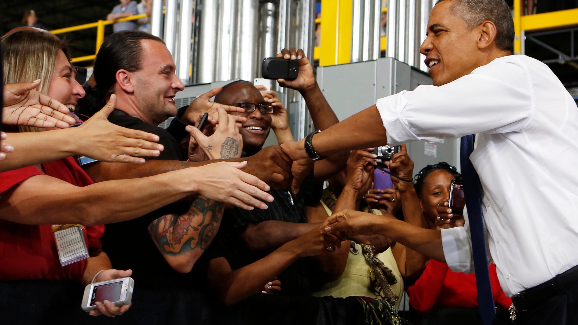 July 30, 2013: President Obama shakes hands before speaking to employees after he tours the Amazon Fulfillment Center in Chattanooga, Tennessee.