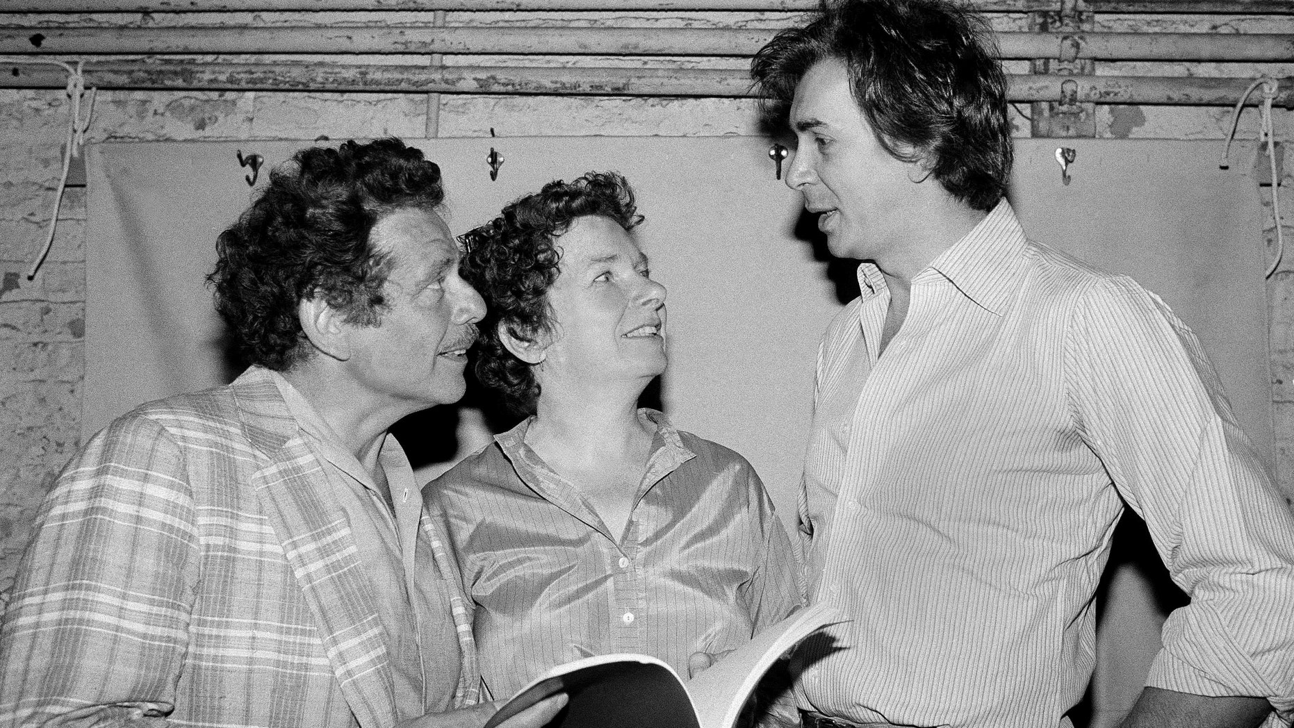 In this Aug. 18, 1980, file photo, actor Frank Langella, right, talks with Jerry Stiller, left, and Angela Paton at the Morosco Theater in New York.