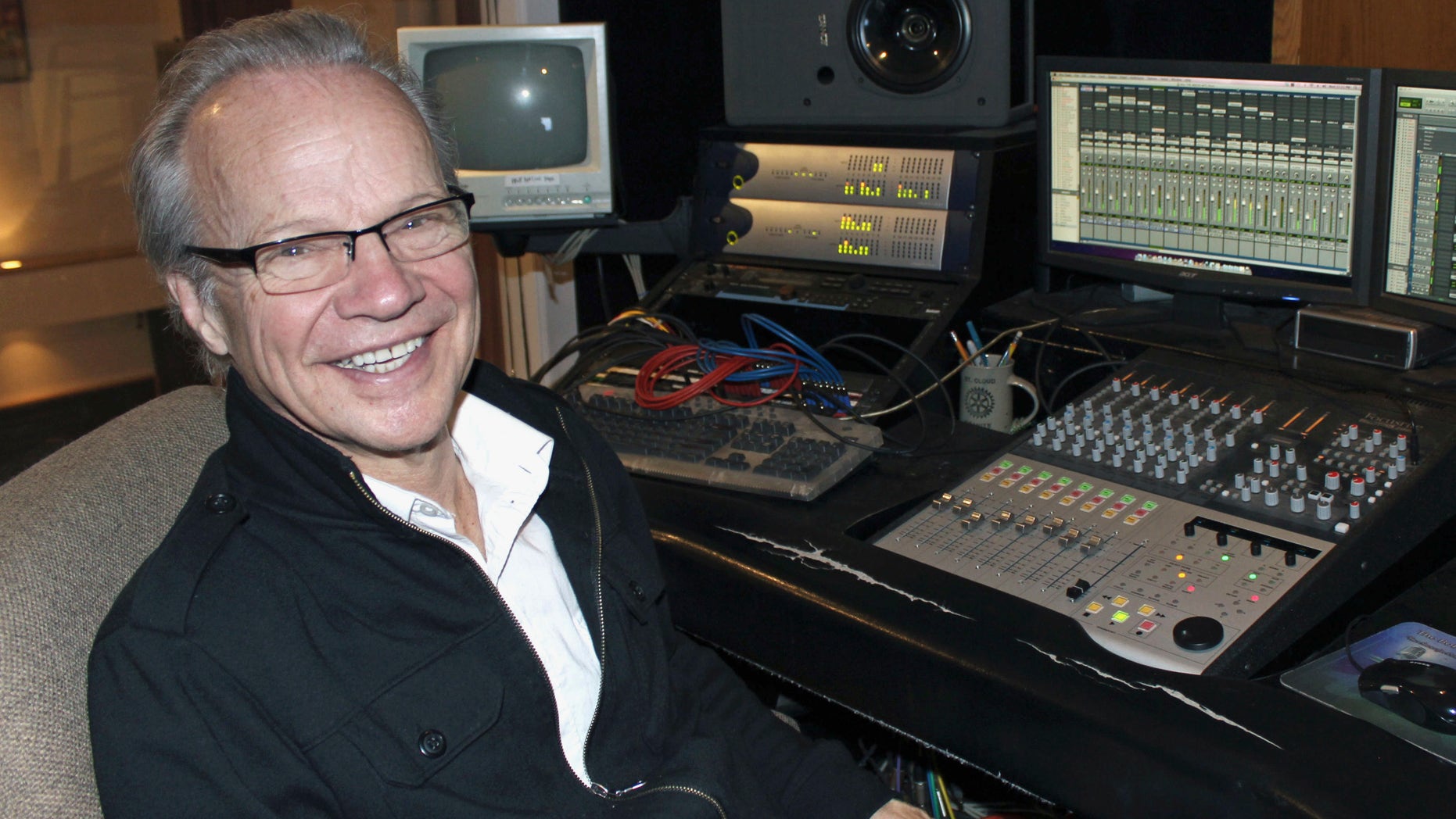 FILE - In this Dec. 18, 2013 file photo, Bobby Vee poses at the studio console at his family's Rockhouse Productions in St. Joseph, Minn. Vee, whose rise toward stardom began as a 15-year-old fill-in for Buddy Holly after Holly was killed in a plane crash, died Monday Oct. 24, 2016 of complications from Alzheimer's disease. He was 73. (AP Photo/Jeff Baenen, File)