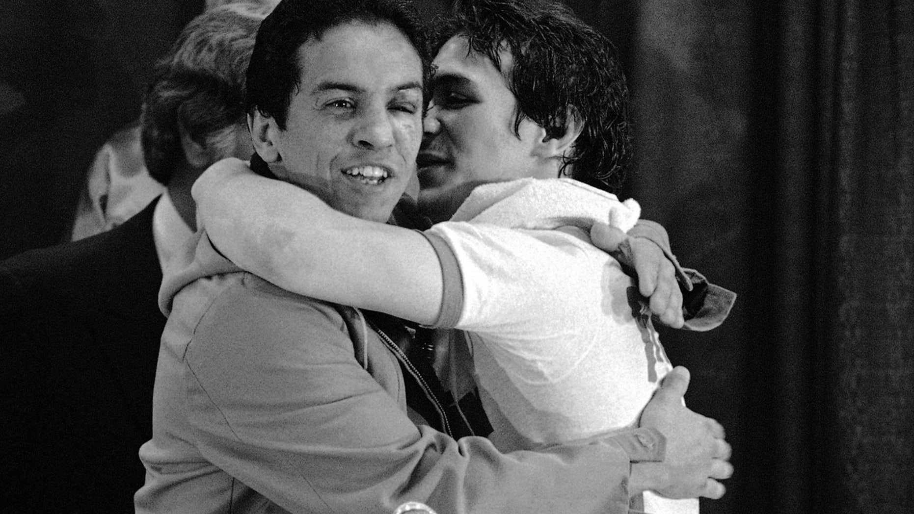 In this Nov. 14, 1984 file photo, WBA lightweight champ Ray Mancini, right, gives challenger Bobby Chacon a hug after defeating him in a title fight at Reno, Nev. Chacon, a Hall of Fame boxer, died Wednesday, Sept. 7, 2016, under hospice care for dementia in Lake Elsinore, Calif. He was 64.