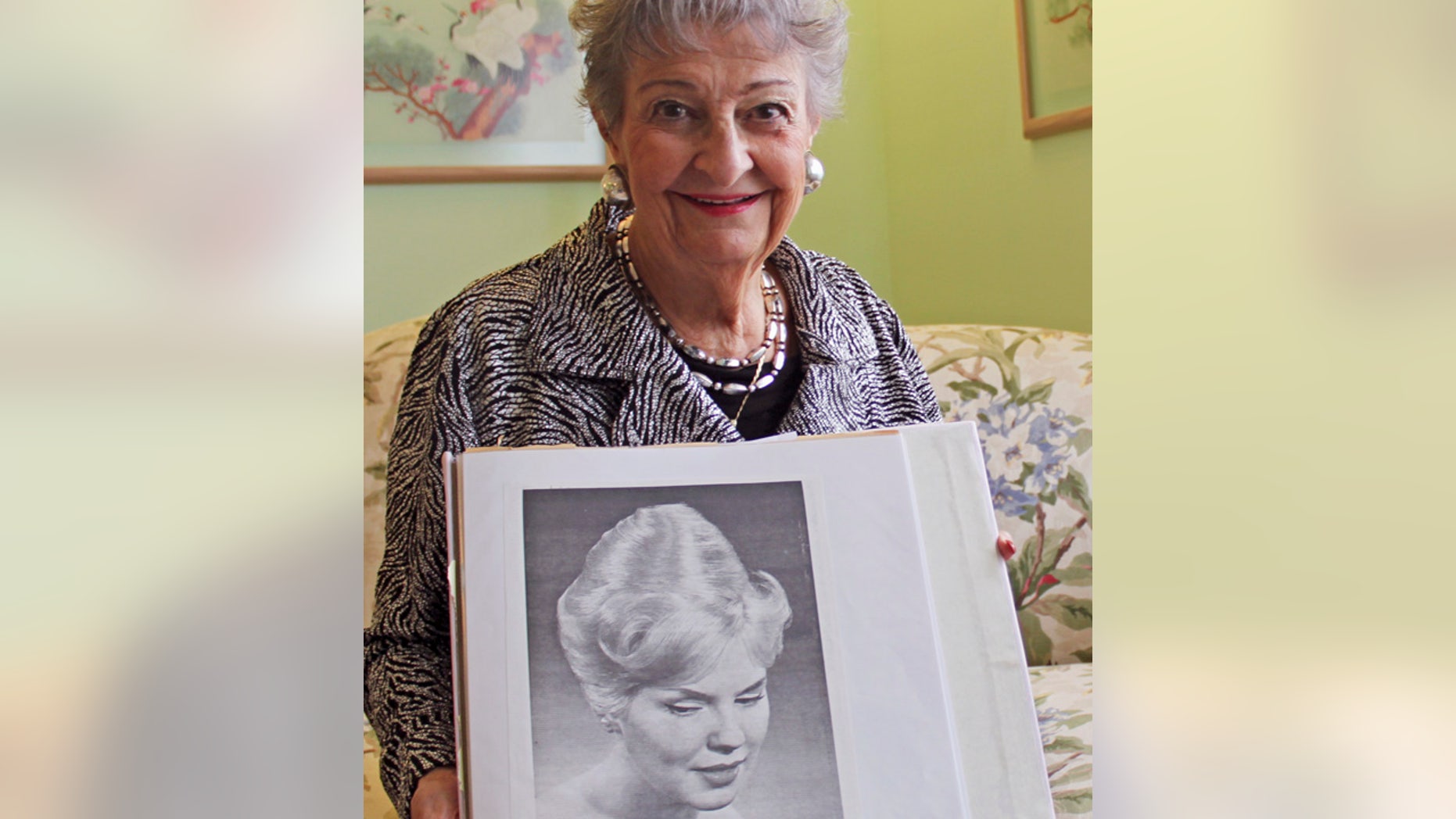 FILE - Jan. 19, 2011:Retired hairstylist Margaret Vinci Heldt with a photo of a model with a "beehive" hairdo from the February 1960 edition of Modern Beauty Shop magazine.