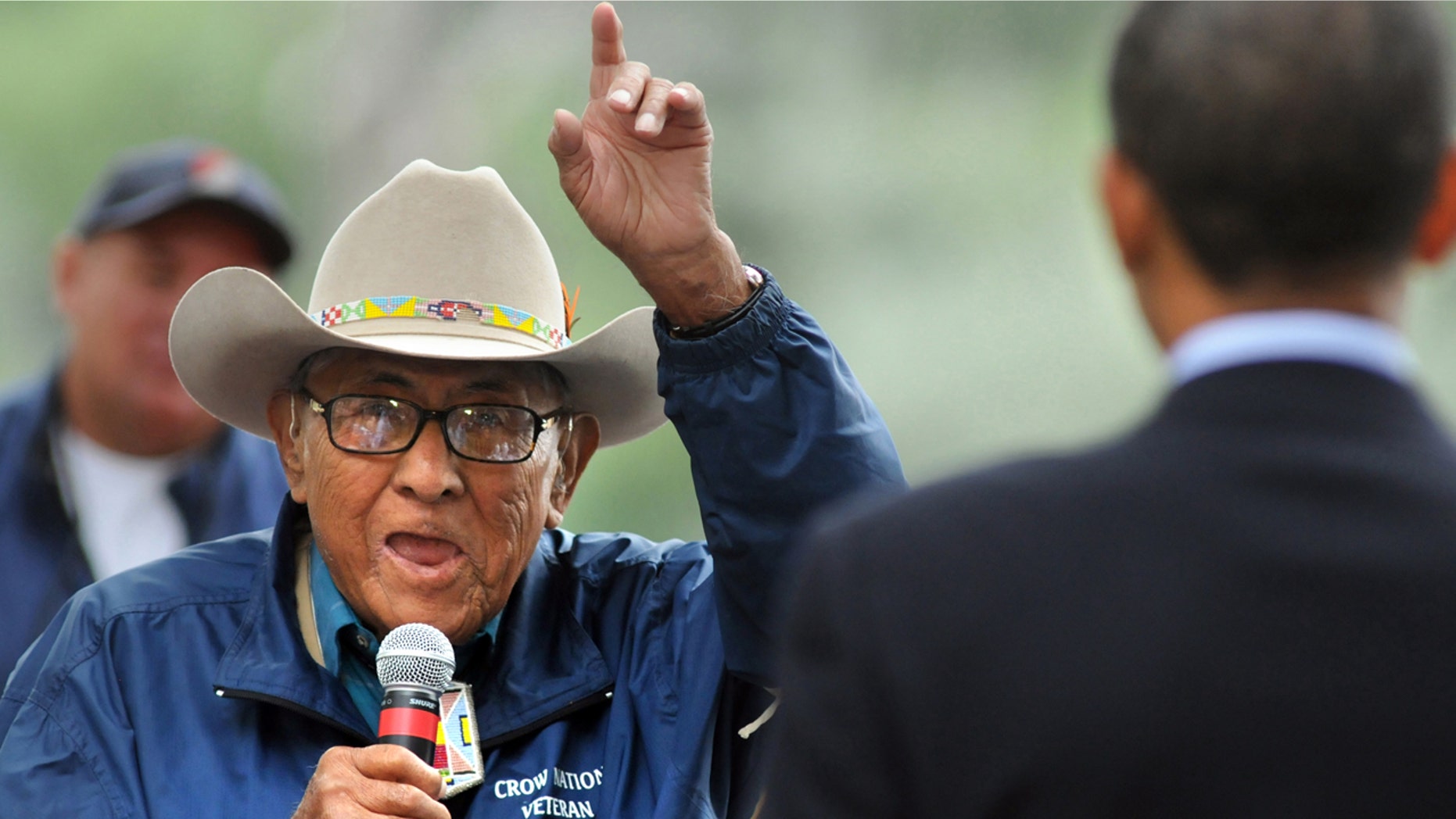 In this Aug. 27, 2008 file photo, Native American Crow historian Joe Medicine Crow tells then-presidential-candidate Barack Obama to "take veterans to the top when you move into the White House," during a visit to Billings, Mont.