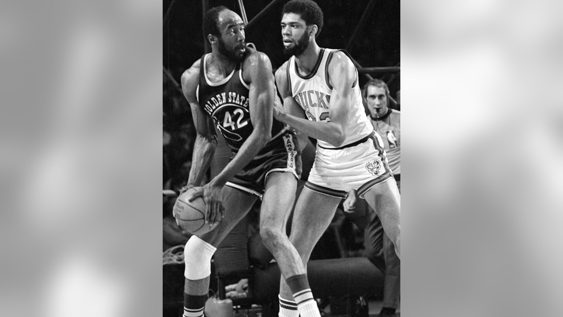 March 30, 1973: Nate Thurmond of the Golden State Warriors (42) looks back at Kareem Abdul-Jabbar of the Milwaukee Bucks before making his move toward the basket during NBA playoff action at Milwaukee, Wis.