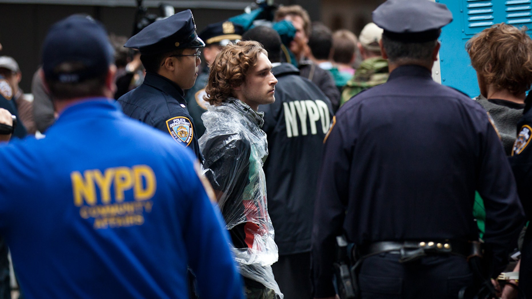 A demonstrator affiliated with Occupy Wall Street protests is arrested during a march near the financial district's Zucotti park, Monday, Oct. 12, 2011, in New York as the protest entered its fourth week.