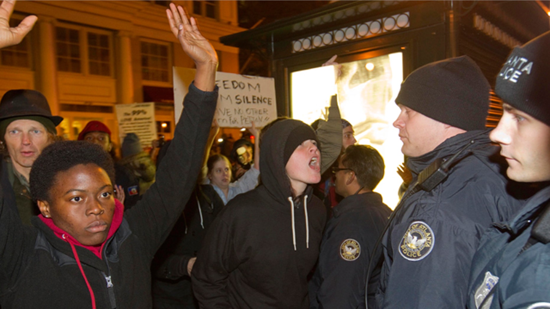 Nov. 5, 2011: A protestor yells at police after Occupy Atlanta protestors and an officer clashed as he was driving through the crowd on a motorcycle in Atlanta.