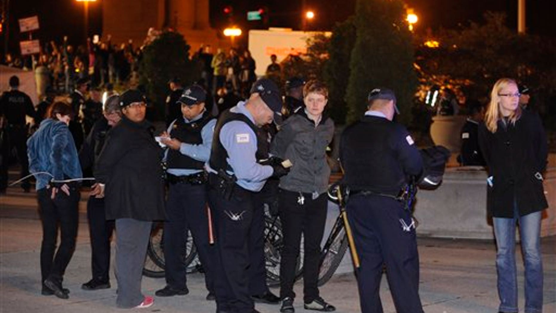 Oct. 23, 2011: Protesters are arrested during an Occupy Chicago march and protest at Grant Park in Chicago. Demonstrators of the anti-Wall Street group Occupy Chicago stood their ground in a downtown park and defied police orders to clear the area, prompting police to make more than a dozen arrests early Sunday.