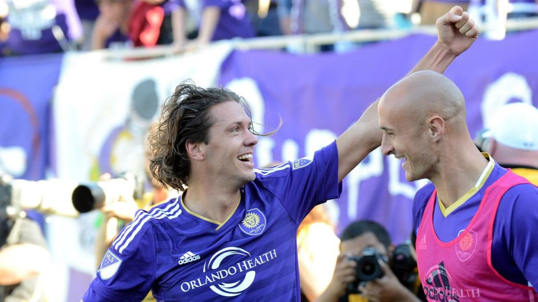 Mar 6, 2016; Orlando, FL, USA; Orlando City SC midfielder Adrian Winter (32) celebrates with his teammates after scoring the game tying goal in stoppage time against Real Salt Lake at Orlando Citrus Bowl Stadium. Mandatory Credit: Jonathan Dyer-USA TODAY Sports