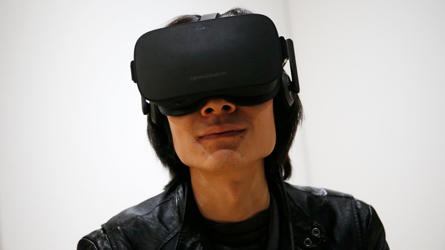 File photo - Peijun Guo wears the Oculus Rift VR headset at the Oculus booth at CES International, Wednesday, Jan. 6, 2016, in Las Vegas. (AP Photo/John Locher)