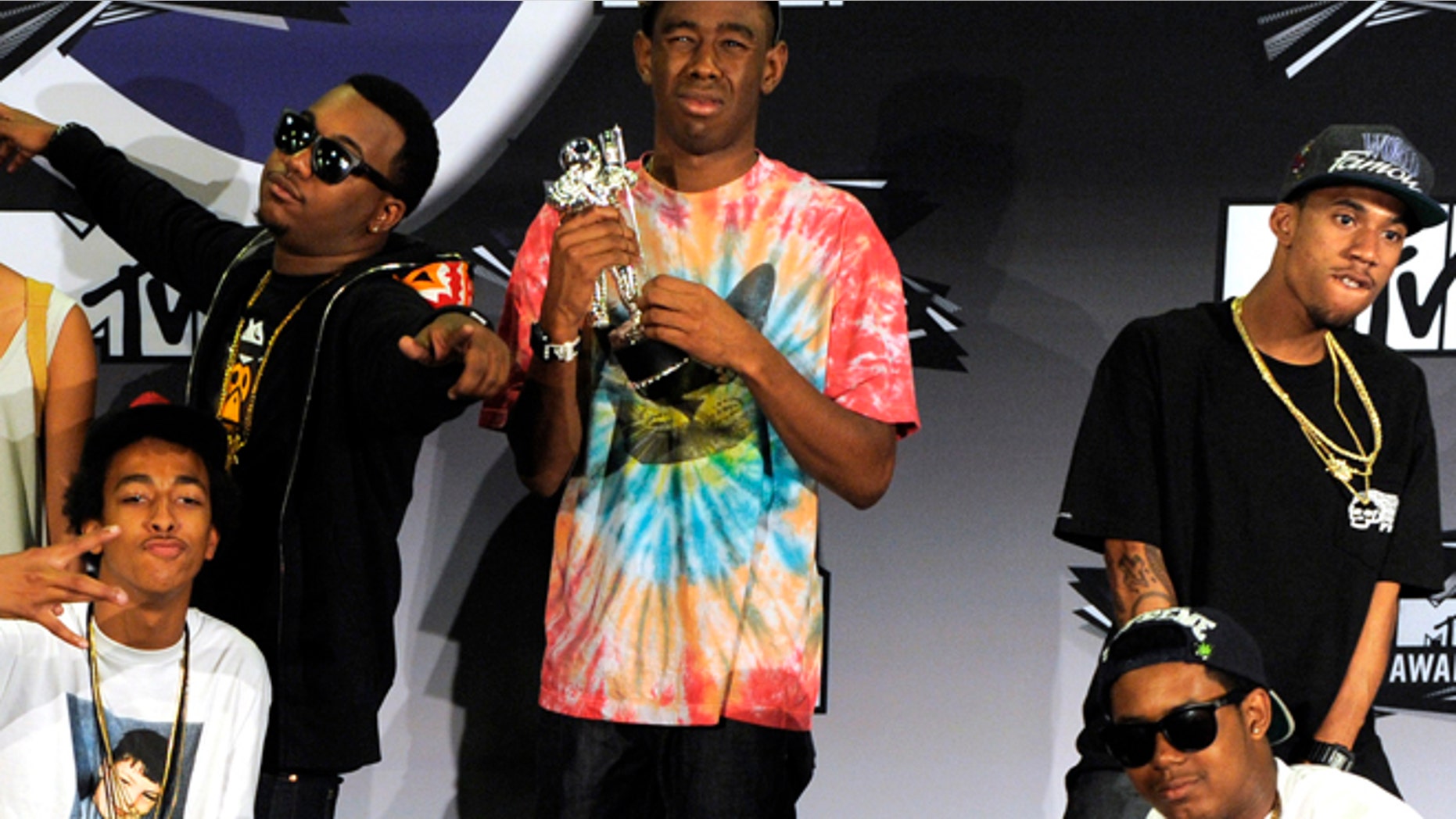 In this Aug. 28, 2011 file photo, Tyler, The Creator, center, holds the award for best new artist as he poses with other members of Odd Future at the MTV Video Music Awards in Los Angeles. New Zealand immigration authorities have banned the Los Angeles rappers from entering the country.