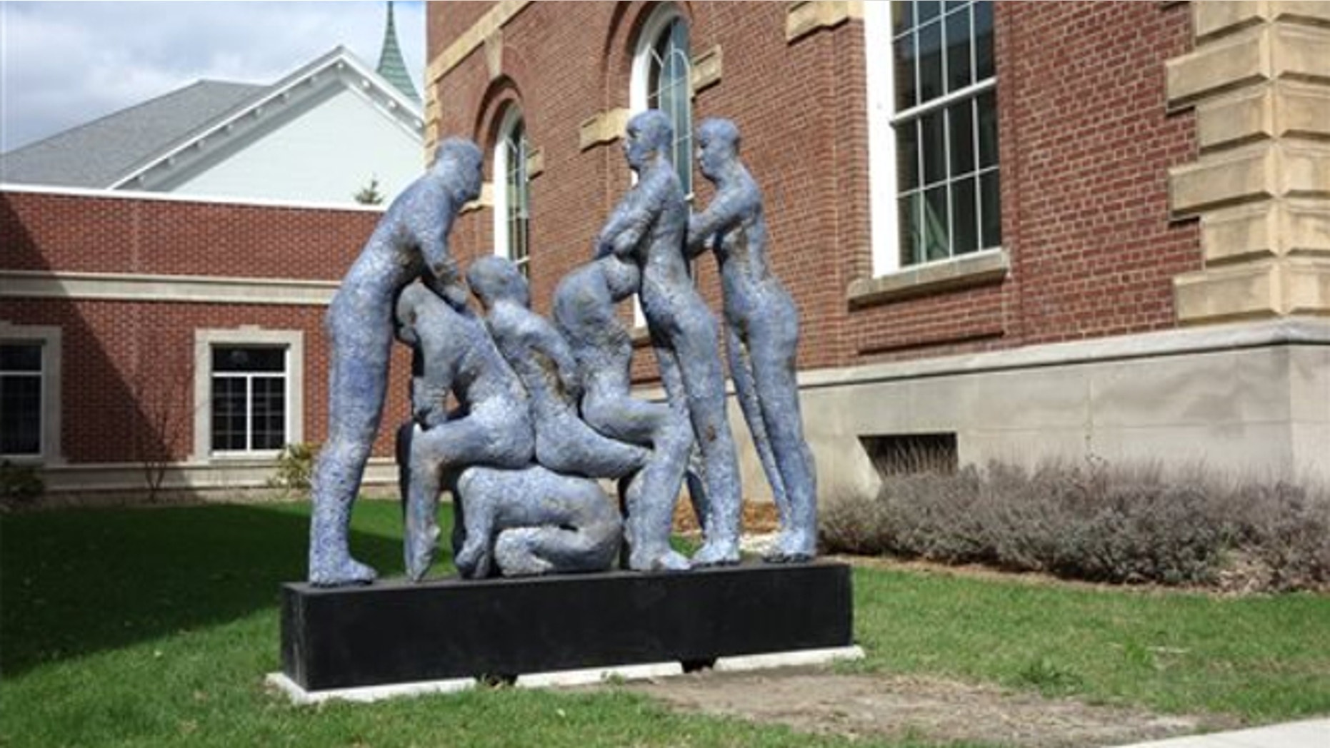 April 22, 2014: The sculpture "Blue Human Condition" by Williamston, Mich., artist Mark Chatterley, is shown next to city offices in Adrian, Mich. City officials have decided to move the sculpture after complaints that it was too racy.