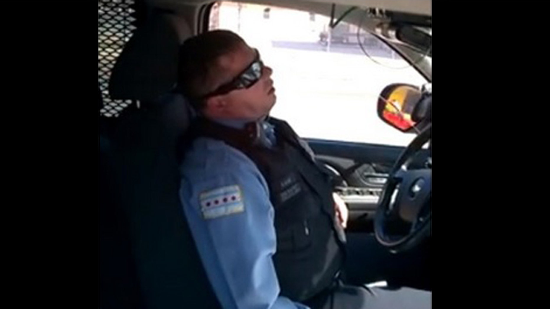 A video of a Chicago officer sleeping in his SUV parked on a busy street has gone viral.