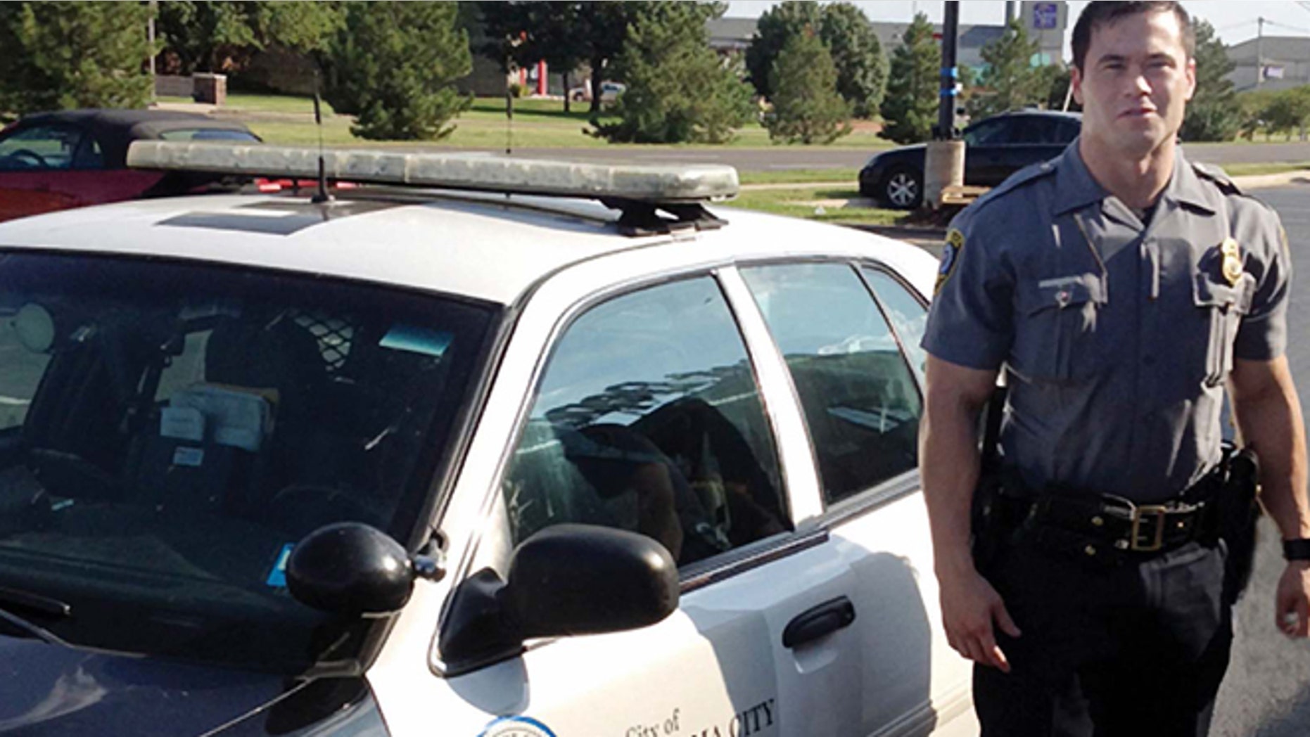 Sept. 2, 2012: In this file photo, provided by the Oklahoma Police Dept., Oklahoma City police officer Daniel Holtzclaw stands next to his vehicle.
