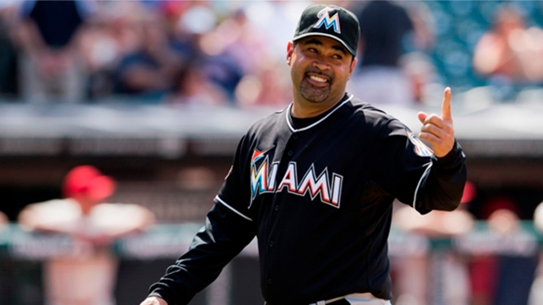 CLEVELAND, OH - MAY 20: Manager Ozzie Guillen #13 of the Miami Marlins gestures to first base after a pitching change during the eighth inning against the Cleveland Indians at Progressive Field on May 20, 2012 in Cleveland, Ohio. The Marlins defeated the Indians 5-3. (Photo by Jason Miller/Getty Images) *** Local Caption *** Ozzie Guillen