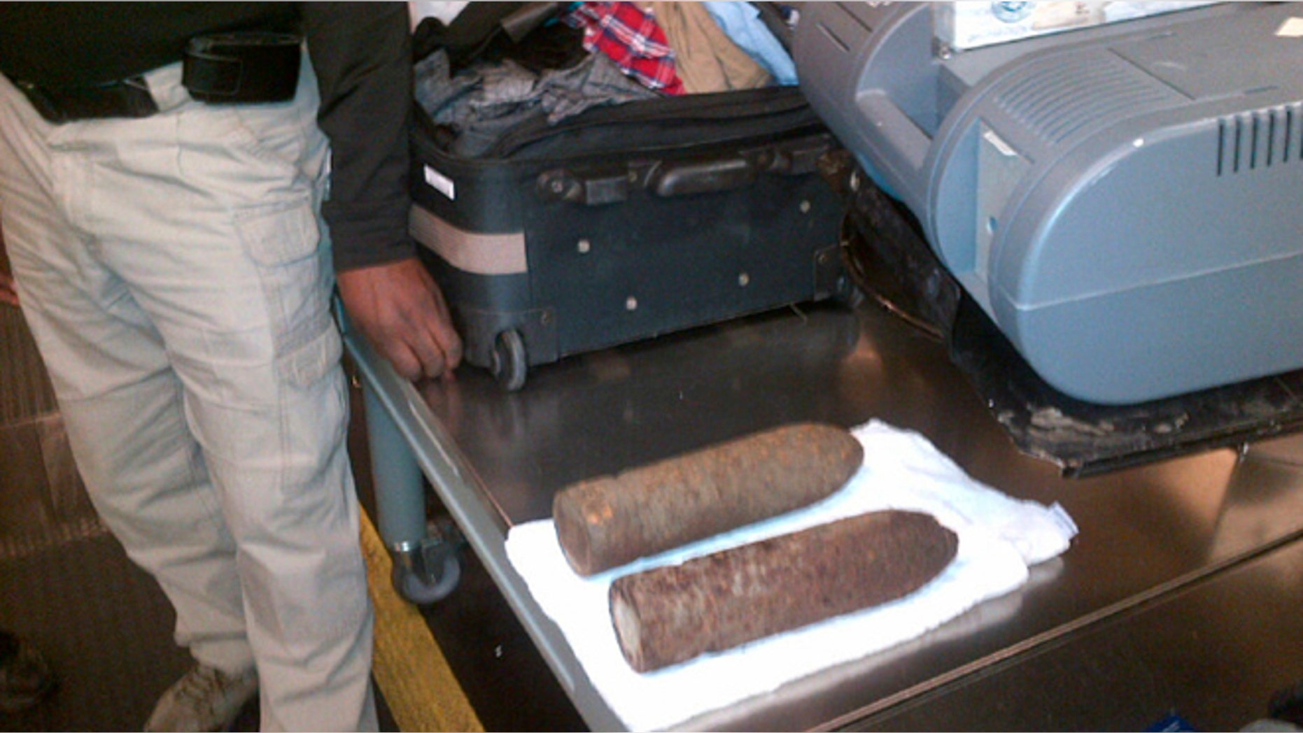 This Monday, April 7, 2014 photo provided by the Transportation Security Administration (TSA) shows two World War I artillery shells discovered by baggage screeners in checked luggage that arrived on a flight from London at Chicago's O'Hare International Airport. The TSA says the bags belonged to a 16-year-old and a 17-year-old who were returning from a school field trip to Europe. A bomb disposal crew determined the shells were inert and no one was ever in danger. The teens were questioned then allowed to travel onward. They weren't charged. (AP/Transportation Security Administration)
