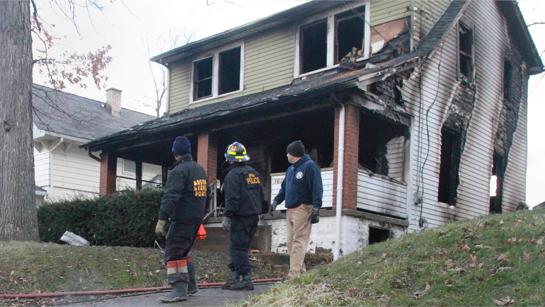 March 30, 2015: Fire personal investigate an early house fire in Youngstown, Ohio. Autopsies are scheduled for three people who died in the house fire, including a 10-year-old girl who prosecutors say was connected to a rape trial set to begin later that day.