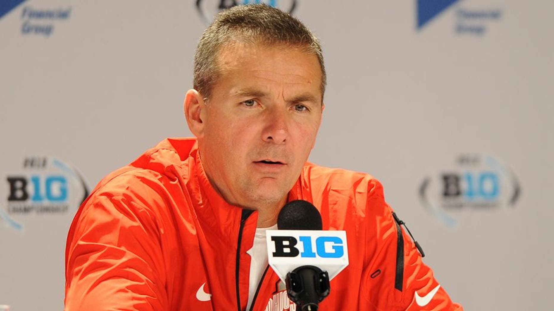 INDIANAPOLIS, INDIANA - DECEMBER 7, 2013: Head coach Urban Meyer of the Ohio State Buckeyes answers questions from the media during the post game press conference after a game against the Michigan State Spartans at Lucas Oil Stadium in Indianapolis, Indiana. The Spartans won 34-24. (Photo by David Dermer/Diamond Images/Getty Images)