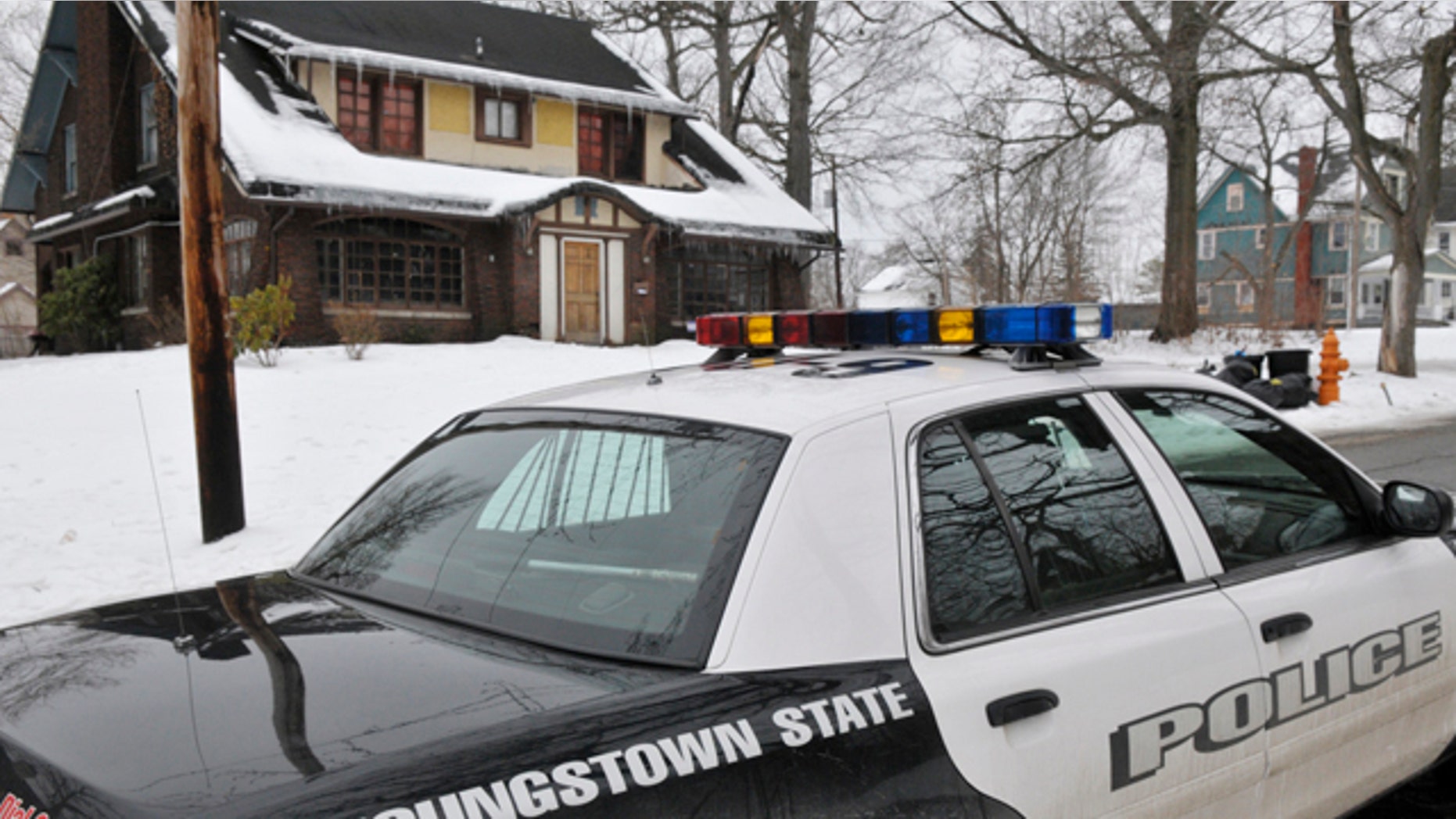 Feb. 6, 2011: A Youngstown State Police University officer patrols the street near the location of an early morning shooting at a fraternity house just north of the Youngstown State University campus that left student Jamail E. Johnson, 25 of Youngstown dead and 11 injured in Youngstown, Ohio.