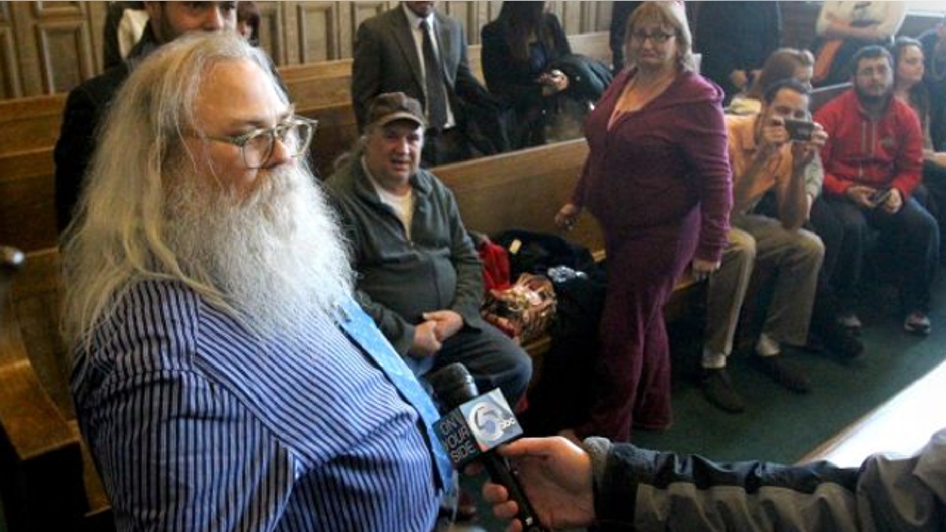 Jan. 30, 2014: Family and friends watch as Dewey Jones, left, speaks to the media after a hearing before Summit County Common Pleas Court Judge Mary Margaret Rowlands in Akron, Ohio.