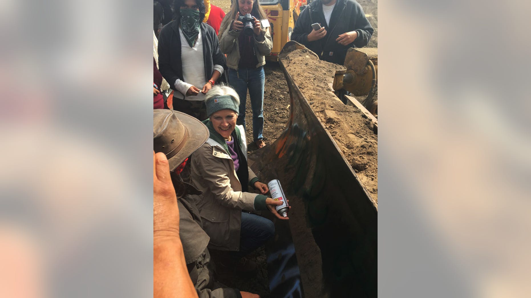 Sept. 6, 2016: Green Party presidential candidate Jill Stein prepares to spray-paint "I approve this message" in red paint on the blade of a bulldozer at a protest against the Dakota Access Pipeline in the area of Morton County, N.D.