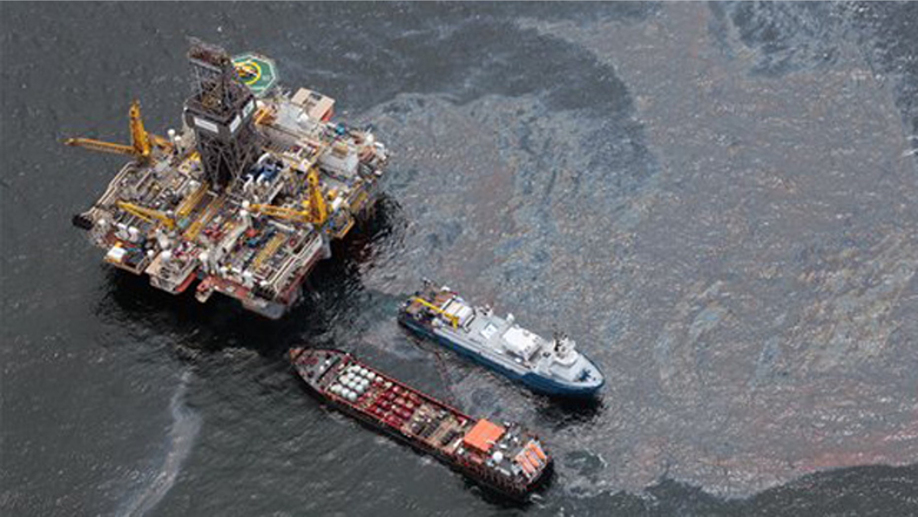 July 16, 2010: Workboats operate near the Transocean Development Drilling Rig II at the site of the Deepwater Horizon incident in the Gulf of Mexico. The wellhead has been capped and BP is continuing to test the integrity of the well before resuming production.