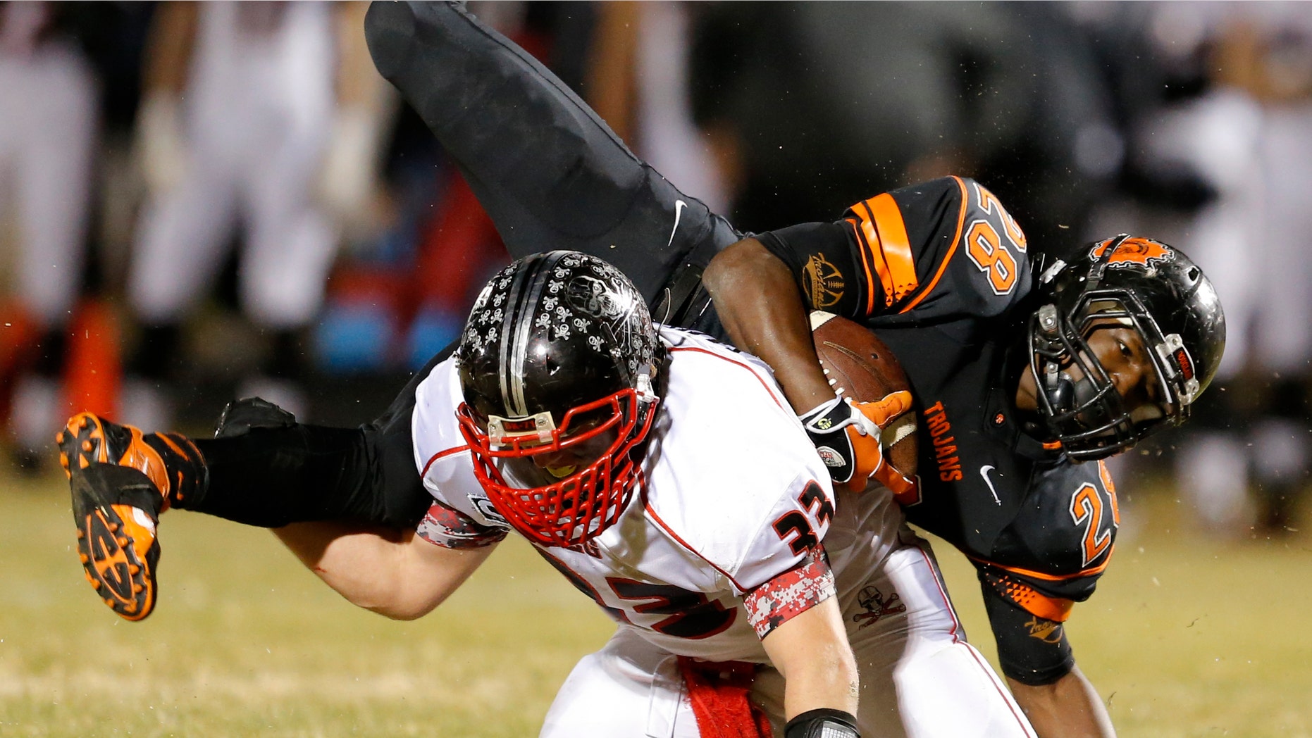 Nov. 28, 2014: Douglass High School's Anthony Jackson (28) is brought down by Locust Grove High School's Vance Wilson during a their Class 3A high school football quarterfinal playoff game in Oklahoma City.