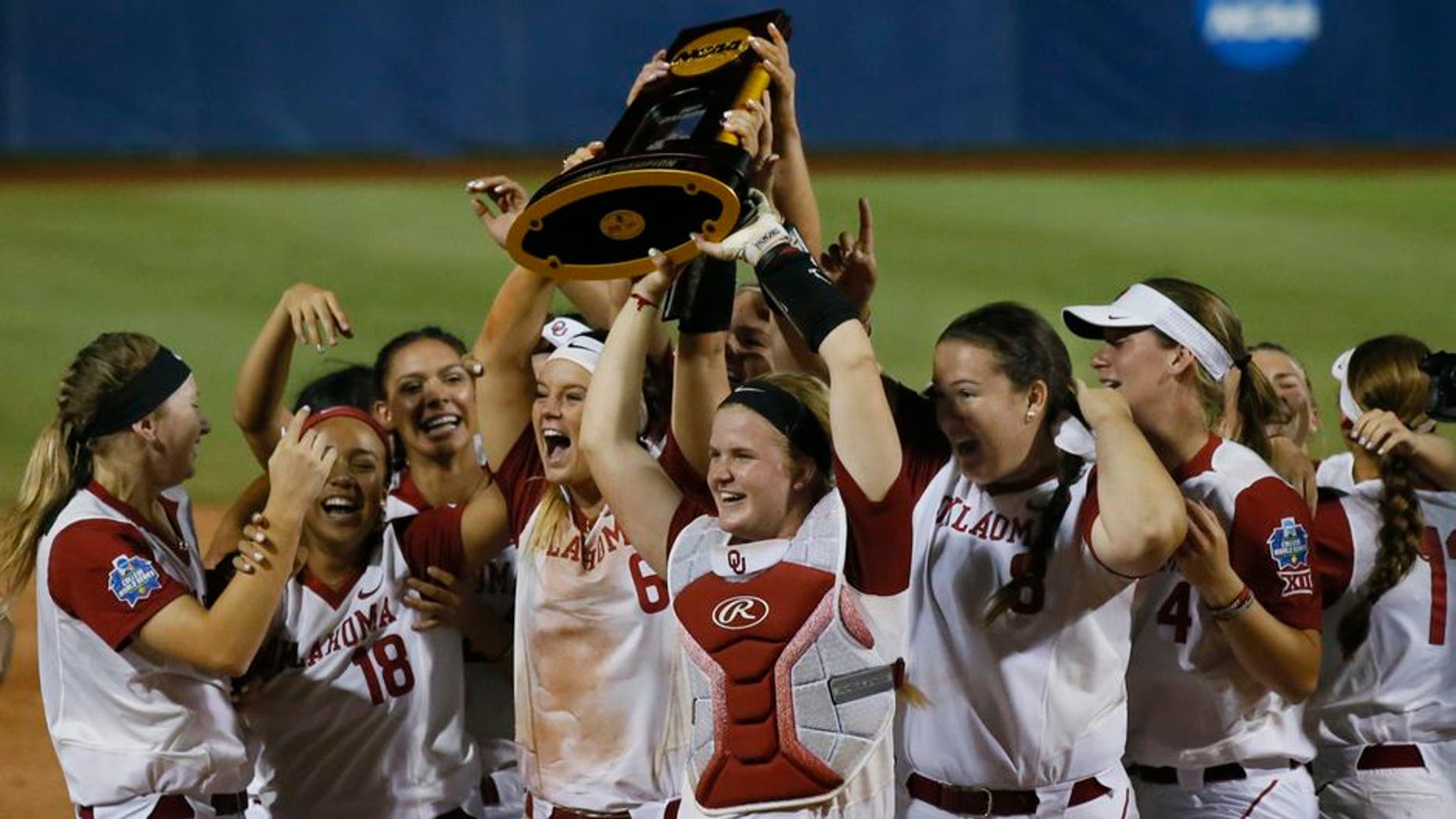 The Oklahoma team celebrates after defeating Florida in the second game of the best-of-three championship series in the NCAA Women's College World Series in Oklahoma City, Tuesday, June 6, 2017. Oklahoma won the game 5-4, and the championship. (AP Photo/Sue Ogrocki)