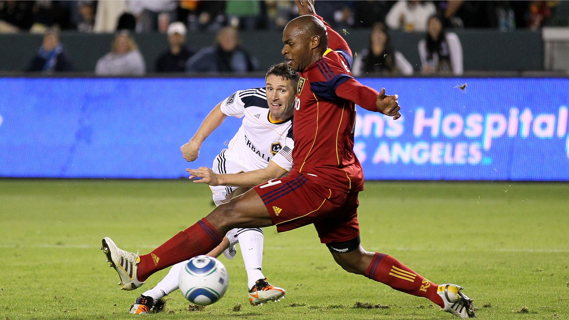 CARSON, CA - NOVEMBER 06: Robbie Keane #14 of the Los Angeles Galaxy gets a shot past Jamison Olave #4 of Real Salt Lake to score the Galaxy's third goal in the MLS Western Conference Championship at The Home Depot Center on November 6, 2011 in Carson, California. The Galaxy won 3-1 to advance to the MLS Cup. (Photo by Stephen Dunn/Getty Images)